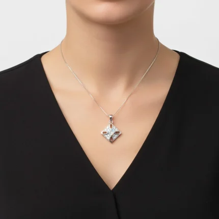 model wearing fancy square shaped rainbow moonstone silver pendant with cubic zirconia